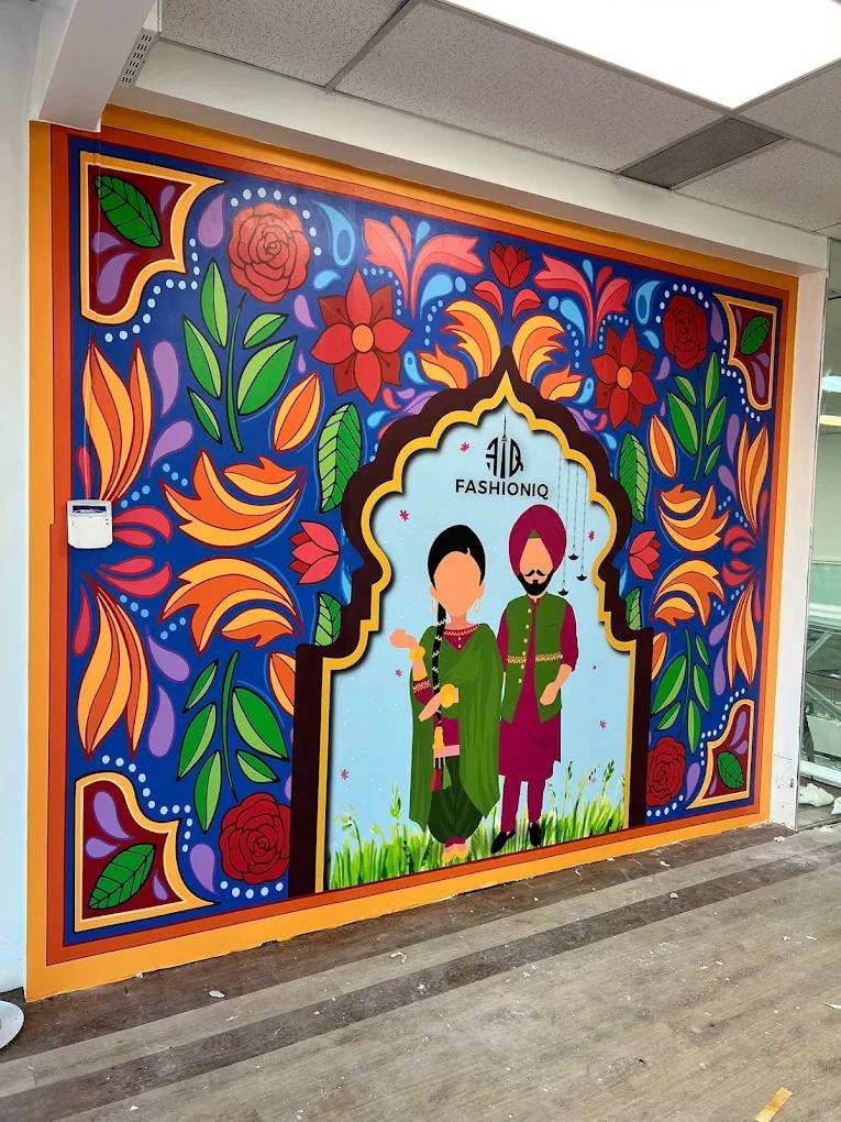 Colourful floral folk-art wall mural with the Fashioniq logo