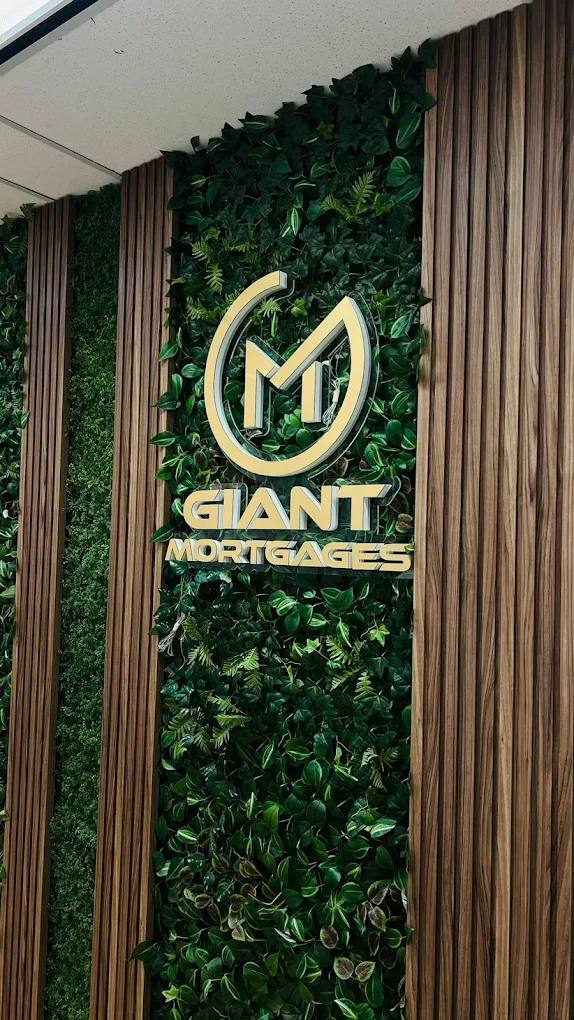 Gold Giant Mortgages logo sign on a green living wall in an office lobby