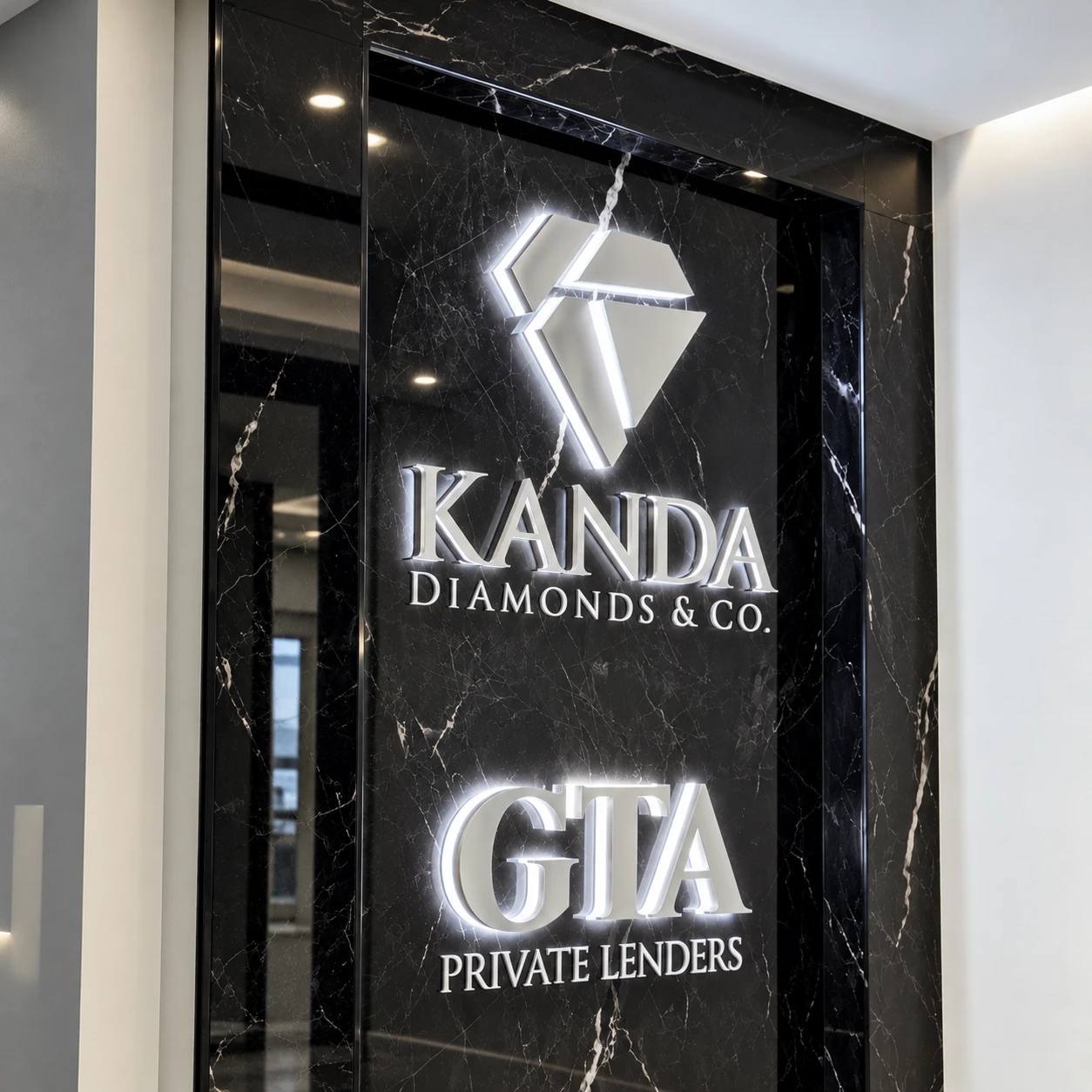 Halo-lit dimensional logos on a black marble lobby wall