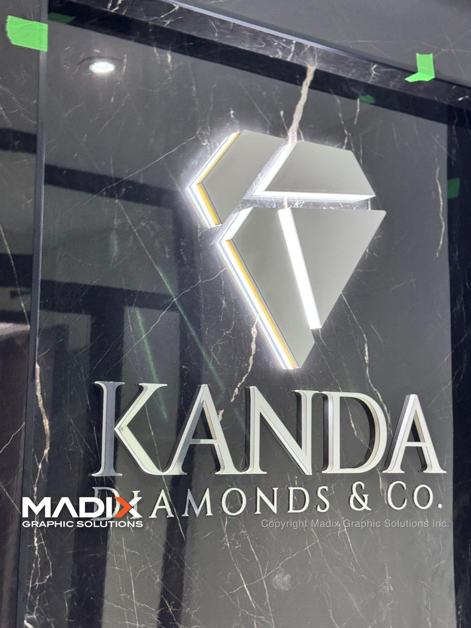 Halo-lit logo sign on a marble wall