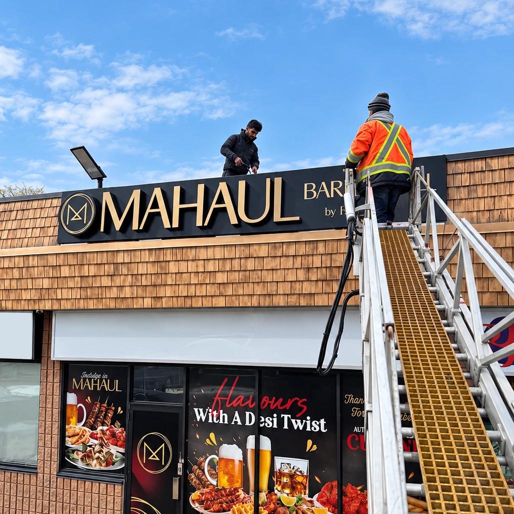Madix installers mounting a storefront sign