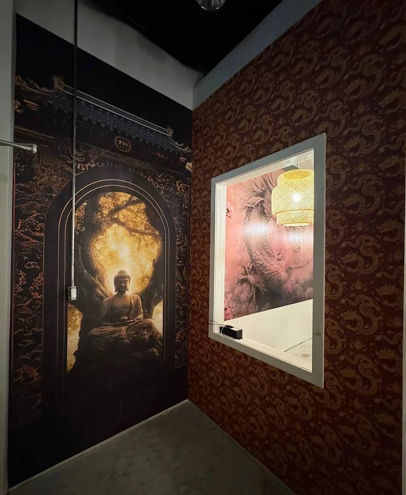 Printed Buddha wall mural beside a red and gold dragon pattern wallcovering in a restaurant