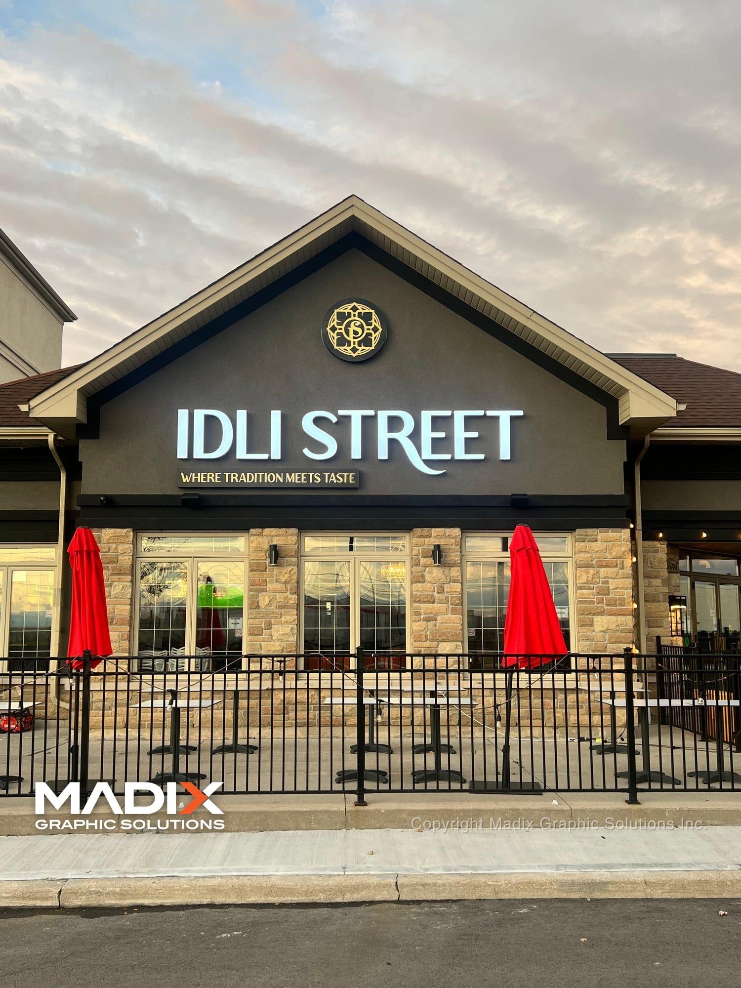 Storefront sign on a restaurant with a patio